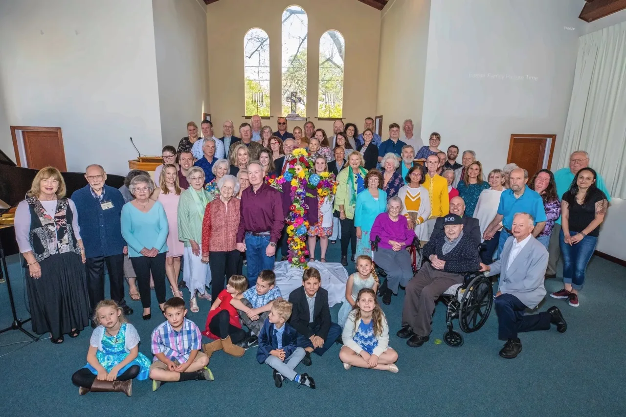 The Sonoma Valley Community Church congregation gathered together in the sanctuary around the Easter flower cross