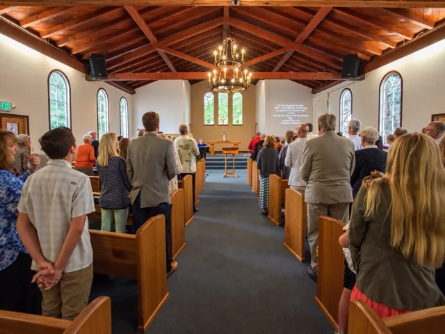Congregation standing together for worship in the church sanctuary